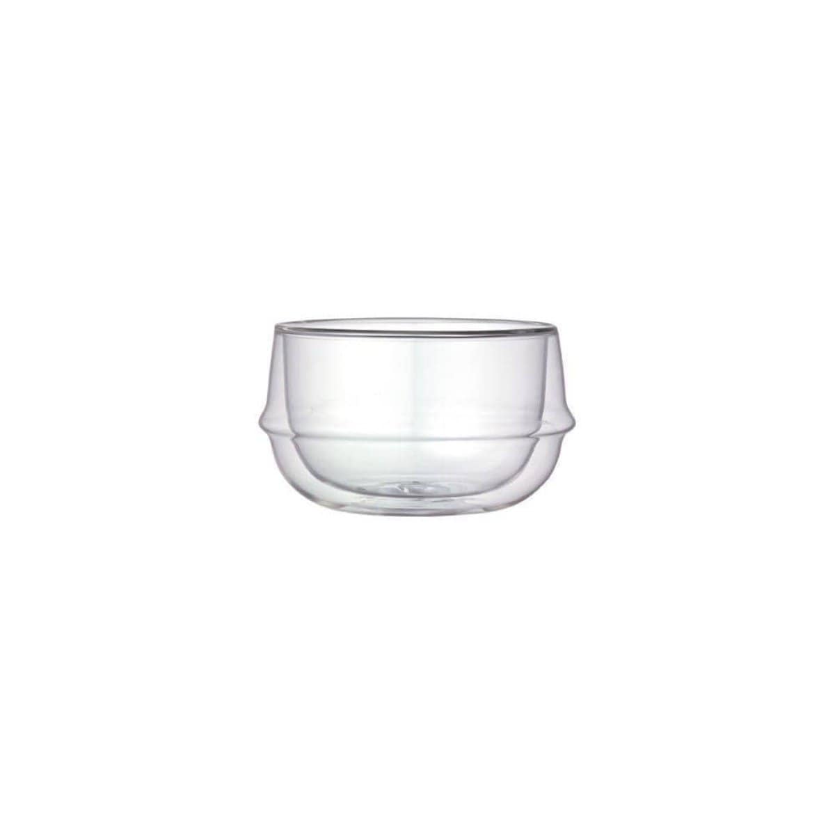 A Kinto Double-Walled Teacup with a double-wall design. The teacup is round with a slight indentation around the middle, giving it a unique, modern appearance. Perfect for showcasing organic tea or loose leaf tea, its transparency highlights the double thickness of the glass walls against a plain white background.