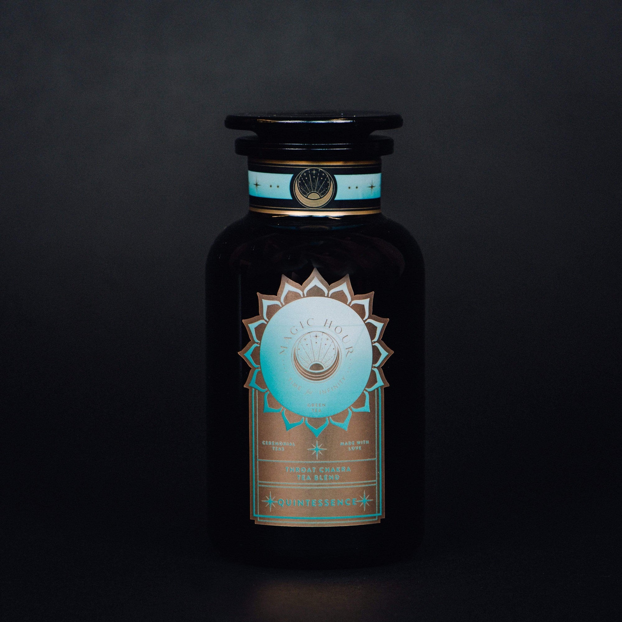 A bottle with a logo on it, perfect for storing your favorite Magic Hour Quintessence™ Tea for Opening & Healing the Throat Chakra.