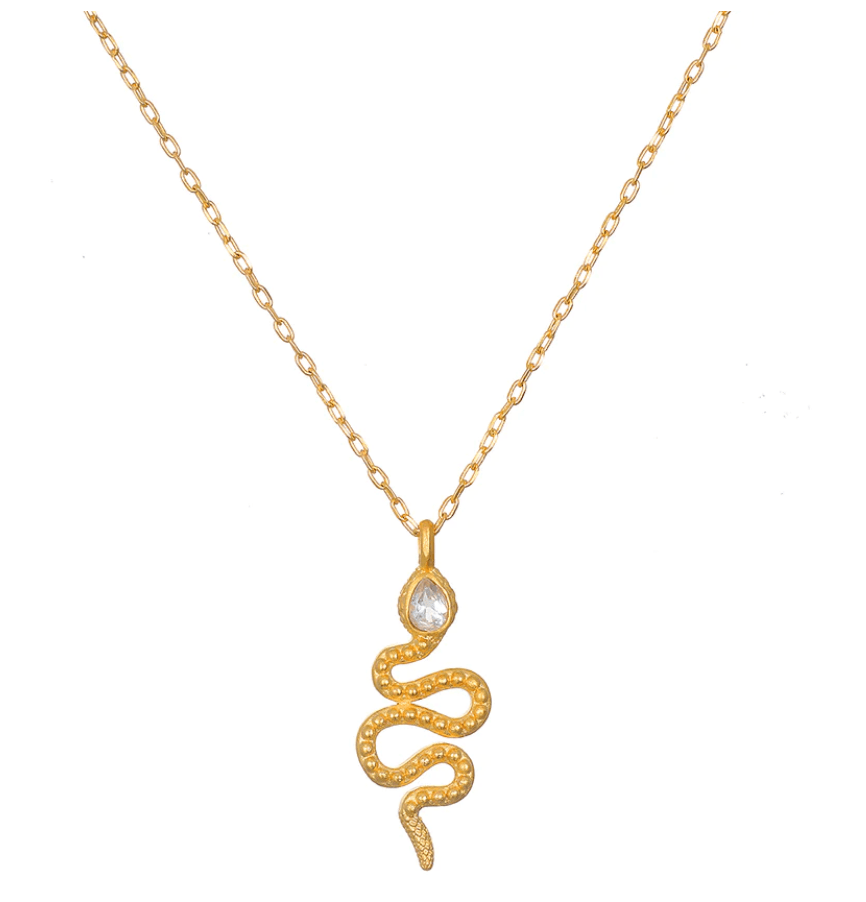 The Enduring Individuality White Topaz Snake Necklace is a stunning piece featuring an 18kt gold plate chain with small, interlocking links and a detailed pendant shaped like a serpent symbol. The snake boasts intricate markings for added texture and depth, and near its head, it sparkles with a shimmering, teardrop-shaped white topaz detail.